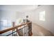Hallway with stairs, wrought iron railing, tiled floors, and natural light at 204 N Ring Dove Dr, Las Vegas, NV 89144
