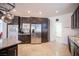 Well-equipped kitchen with stainless steel appliances, granite countertops, dark wood cabinets, and open layout at 204 N Ring Dove Dr, Las Vegas, NV 89144