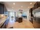 Bright and open kitchen with a central island, stainless steel appliances, and a view to the dining area and living room at 204 N Ring Dove Dr, Las Vegas, NV 89144