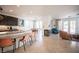 Bright kitchen with a large island, dark cabinets, and easy access to living area at 204 N Ring Dove Dr, Las Vegas, NV 89144
