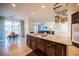 Stylish kitchen island with granite countertop, cooktop, and cabinetry, with views to the dining and living areas at 204 N Ring Dove Dr, Las Vegas, NV 89144