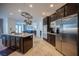 Modern kitchen with a center island, stainless steel appliances, pendant pot rack and open view to living areas at 204 N Ring Dove Dr, Las Vegas, NV 89144