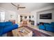 Open-concept living area with fireplace, TV, access to kitchen, and backyard views at 204 N Ring Dove Dr, Las Vegas, NV 89144