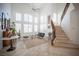 Elegant living room with high ceilings, natural light, and a staircase leading to the upper level at 204 N Ring Dove Dr, Las Vegas, NV 89144