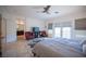 Spacious main bedroom with double doors to a balcony, ceiling fan and tiled flooring at 204 N Ring Dove Dr, Las Vegas, NV 89144