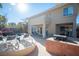 Spacious patio with outdoor kitchen, barbecue, and comfortable seating overlooking the refreshing pool at 204 N Ring Dove Dr, Las Vegas, NV 89144