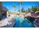Luxurious backyard pool area featuring a rock waterfall, slide, and patio area perfect for relaxation at 204 N Ring Dove Dr, Las Vegas, NV 89144