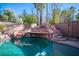 Backyard pool area with a rock waterfall, slide, and plenty of space for entertaining guests at 204 N Ring Dove Dr, Las Vegas, NV 89144