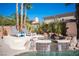 Inviting backyard pool featuring a hot tub, sun loungers, and lush tropical landscaping for outdoor relaxation at 204 N Ring Dove Dr, Las Vegas, NV 89144