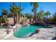 Captivating pool featuring rock accents, a fun slide, and lush landscaping for ultimate relaxation at 204 N Ring Dove Dr, Las Vegas, NV 89144