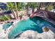 Backyard lagoon style pool and spa featuring a waterfall and rock slide, perfect for outdoor enjoyment at 204 N Ring Dove Dr, Las Vegas, NV 89144