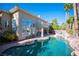 Beautiful pool area with a covered patio, manicured landscaping, and inviting spa, perfect for outdoor living at 204 N Ring Dove Dr, Las Vegas, NV 89144