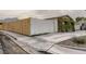 Angle showing exterior, concrete driveway, and wooden fence, enhancing privacy and curb appeal at 2060 Toiyabe St, Las Vegas, NV 89156
