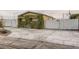 Charming home exterior featuring a spacious driveway and a privacy fence at 2060 Toiyabe St, Las Vegas, NV 89156