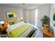 Bright bedroom with a bed, wooden nightstands, and vibrant green accents at 2191 Bay Club Dr # 102, Laughlin, NV 89029