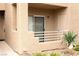 Exterior view of a condo with a private patio, tan stucco walls, and a small potted plant at 2191 Bay Club Dr # 102, Laughlin, NV 89029