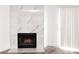 Close-up of a modern fireplace with white marble surround and black trim at 2191 Bay Club Dr # 102, Laughlin, NV 89029