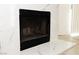Close-up of a modern fireplace with a black mesh screen and tiled surround at 2191 Bay Club Dr # 102, Laughlin, NV 89029