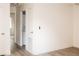 View of hallway features stacked washer/dryer unit and light wood-look flooring at 2191 Bay Club Dr # 102, Laughlin, NV 89029