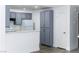 Well-lit kitchen with grey cabinets, white appliances, and breakfast bar at 2191 Bay Club Dr # 102, Laughlin, NV 89029