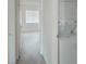 Hallway view includes stacked washer/dryer and leads to windowed room at 2191 Bay Club Dr # 102, Laughlin, NV 89029
