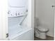 Close up of stacked washer/dryer next to toilet in bathroom at 2191 Bay Club Dr # 102, Laughlin, NV 89029