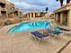 Community pool featuring lounge chairs, tables and a covered patio on a sunny day at 2191 Bay Club Dr # 102, Laughlin, NV 89029