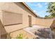 Enclosed back patio with desert landscaping, secure door, and neutral color palette at 2261 Tall Pine Dr, Las Vegas, NV 89108
