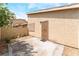 Enclosed back patio with desert landscaping, secure door, and neutral color palette at 2261 Tall Pine Dr, Las Vegas, NV 89108