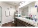 Well-lit bathroom featuring a granite-style countertop, modern vanity, and a glass-enclosed shower, offering a clean and stylish space at 2261 Tall Pine Dr, Las Vegas, NV 89108