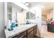 Bright bathroom with granite countertops, a large mirror, and plenty of storage, creating a functional and stylish space at 2261 Tall Pine Dr, Las Vegas, NV 89108