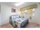 Cozy bedroom with a large window and neutral carpet at 2261 Tall Pine Dr, Las Vegas, NV 89108
