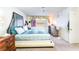 Comfortable bedroom features a large window, light walls, and cozy carpet flooring, creating a peaceful retreat at 2261 Tall Pine Dr, Las Vegas, NV 89108