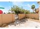 Backyard patio with block fence, metal gate, and desert landscaping at 2261 Tall Pine Dr, Las Vegas, NV 89108