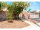Charming front gate surrounded by lush flowering foliage and mature landscaping on a sunny day at 2261 Tall Pine Dr, Las Vegas, NV 89108