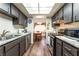 Open-concept kitchen with granite counters, stainless appliances, wood floors, and eat-in dining at 2261 Tall Pine Dr, Las Vegas, NV 89108