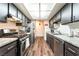 Efficient kitchen with stainless steel appliances, dark wood cabinets, and granite countertops at 2261 Tall Pine Dr, Las Vegas, NV 89108