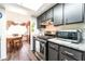 Updated kitchen with stainless steel appliances, granite countertops, and adjacent dining area at 2261 Tall Pine Dr, Las Vegas, NV 89108