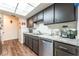 Functional kitchen boasting sleek stainless steel appliances, granite counters, and wood flooring at 2261 Tall Pine Dr, Las Vegas, NV 89108