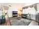 Inviting living room featuring vaulted ceilings, hardwood floors, and a modern entertainment center at 2261 Tall Pine Dr, Las Vegas, NV 89108