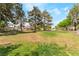 Large grassy yard featuring mature shade trees in front of the townhomes at 2261 Tall Pine Dr, Las Vegas, NV 89108