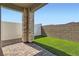 Backyard area with paved patio, low-maintenance landscaping, brick pillar and privacy fencing at 240 White Crest Peak Ave, Henderson, NV 89015