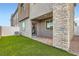 Backyard view of a modern townhome with a small lawn, patio and stone accents at 240 White Crest Peak Ave, Henderson, NV 89015
