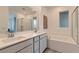 Bright Primary bathroom featuring double sinks, a tub and a shower with glass surround at 240 White Crest Peak Ave, Henderson, NV 89015