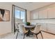 Breakfast nook features a modern round table and chairs beneath a bright window with designer touches at 240 White Crest Peak Ave, Henderson, NV 89015