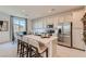 Modern kitchen with stainless steel appliances, white cabinetry, and a breakfast bar island at 240 White Crest Peak Ave, Henderson, NV 89015