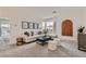 Bright living room with neutral decor, stylish furniture, and large windows at 240 White Crest Peak Ave, Henderson, NV 89015