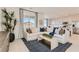 Bright living room open to the kitchen, featuring a large sectional and modern decor at 240 White Crest Peak Ave, Henderson, NV 89015