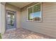 Enclosed patio area featuring brick pavers, exterior door, and large window at 240 White Crest Peak Ave, Henderson, NV 89015
