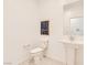 Neutral powder room with pedestal sink and tile floors is perfect for guests at 240 White Crest Peak Ave, Henderson, NV 89015